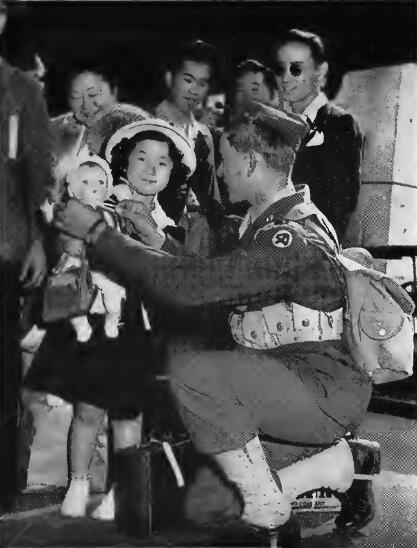 Soldier assists departing evacuees at a Tacoma, Washington