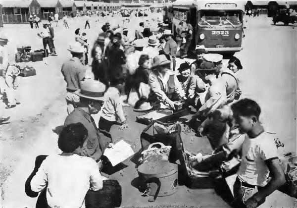 Group of evacuees after arriving by bus at Santa Anita (California) Assembly Center