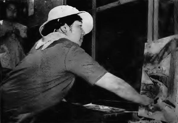 A woman artist at work on a landscape scene at Tanforan (California) Assembly Center