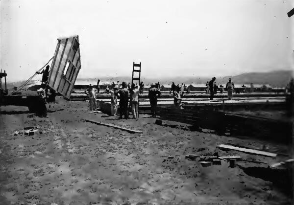 Buildings were put together in sections in a central construction area and these sections hauled by truck to the building site